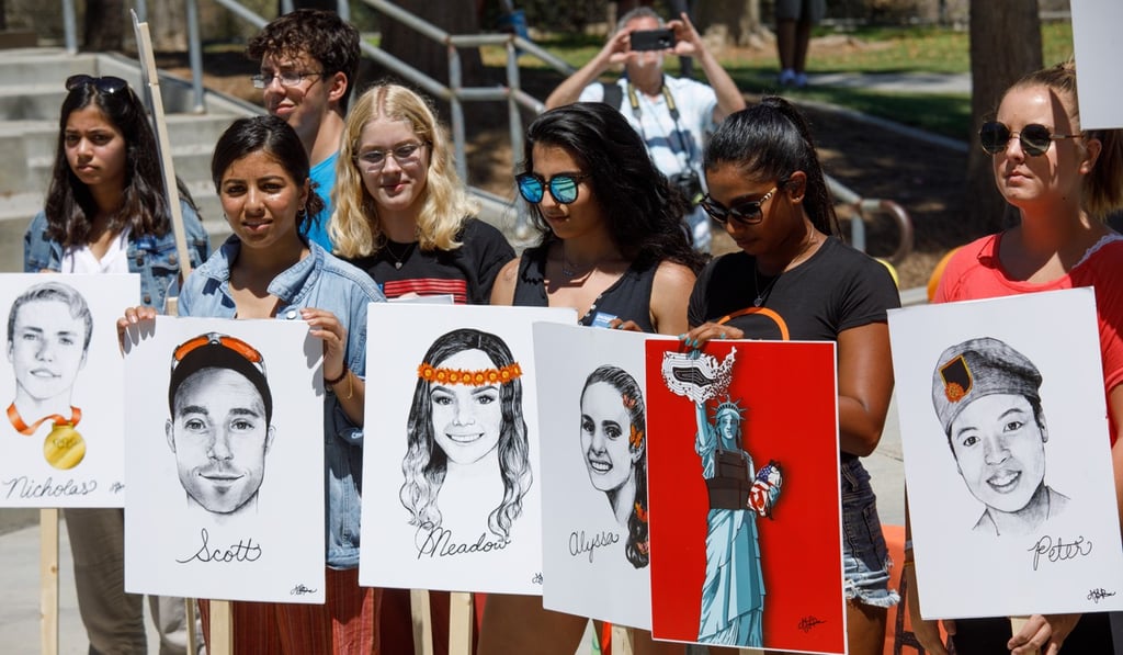 Students in support of gun control protest against the National Rifle Association during a rally in Brea, California on August 4. Participants held pictures of the Parkland school shooting victims. Photo: EPA