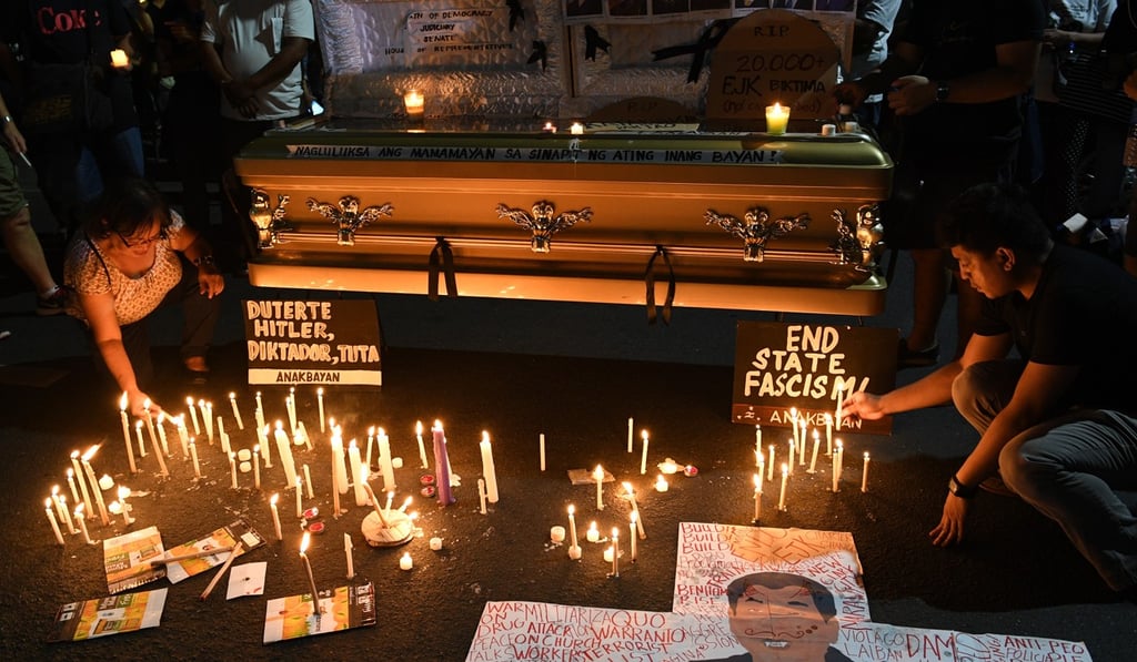 Filipinos decorate a coffin with Duterte’s caricature in Manila. Duterte has faced criticism in the Philippines for his war on drugs. Photo: AFP