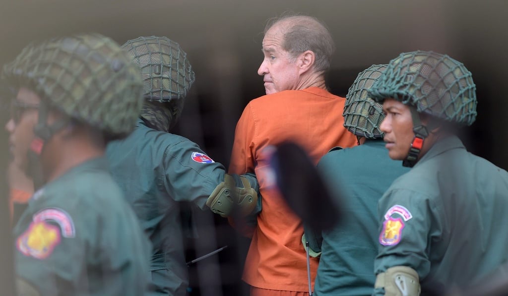 Detained Australian filmmaker James Ricketson is escorted by Cambodian prison guards. The 69-year-old was charged with spying after he flew a drone over an opposition rally in the capital. Photo: AFP Detained Australian filmmaker James Ricketson is escorted by Cambodian prison guards. The 69-year-old was charged with spying after he flew a drone over an opposition rally in the capital. Photo: AFP
