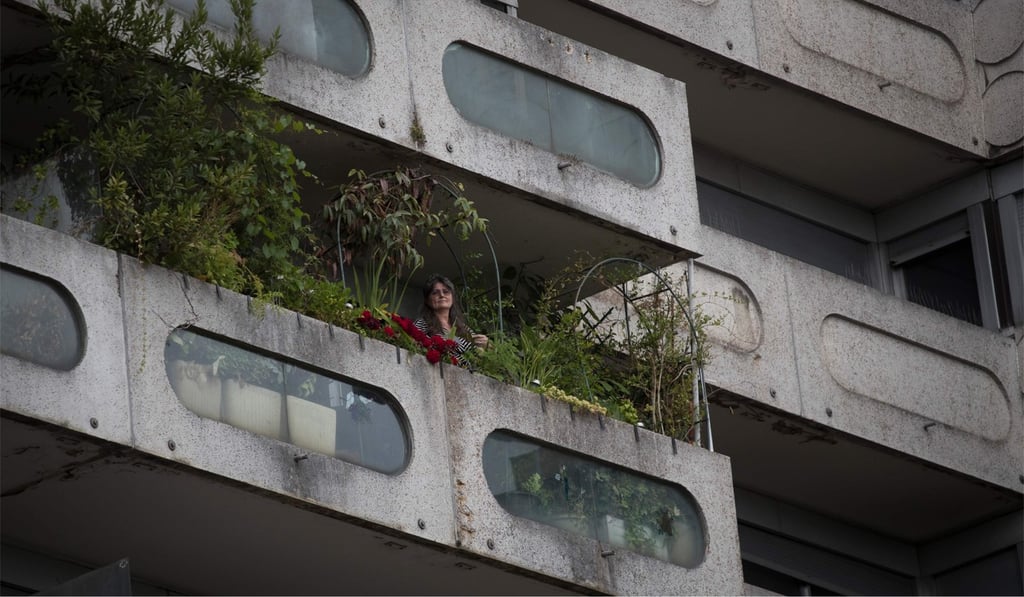 Resident Tatiana Dinulescu on the balcony of her flat at the Damiers Estate. Photo: AFP