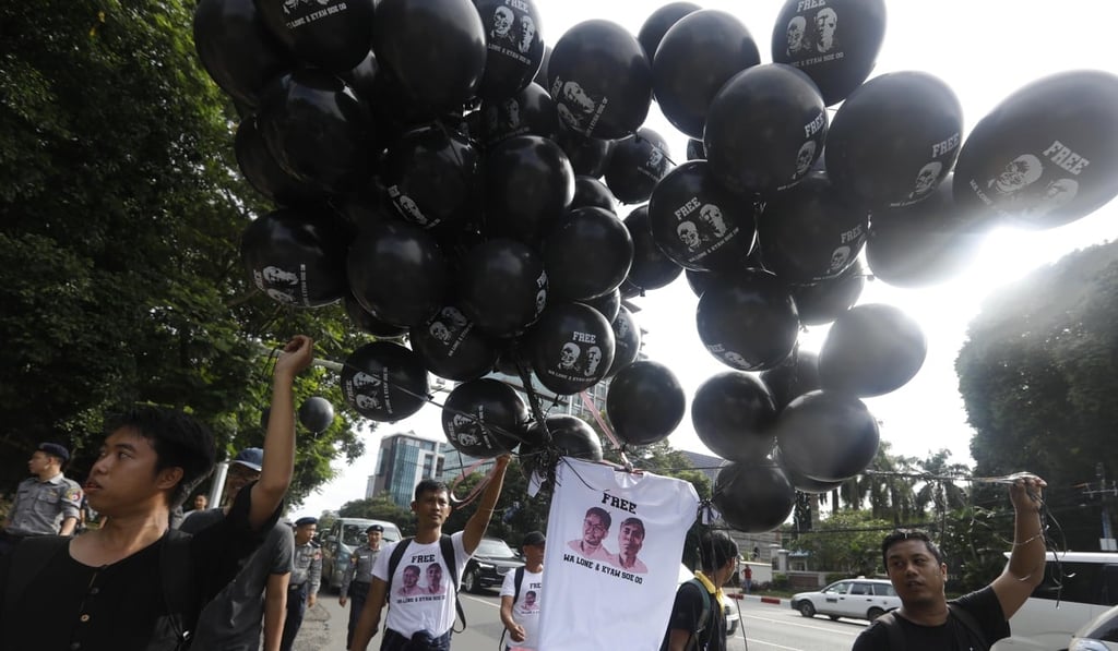Journalists and activists float black coloured balloons and T-shirt printed with the portrait of the two detained Reuters journalists Wa Lone and Kyaw Soe Oo. Photo: EPA-EFE