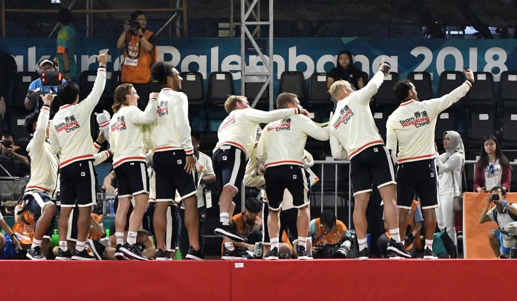 Hong Kong wave to their fans after winning gold.