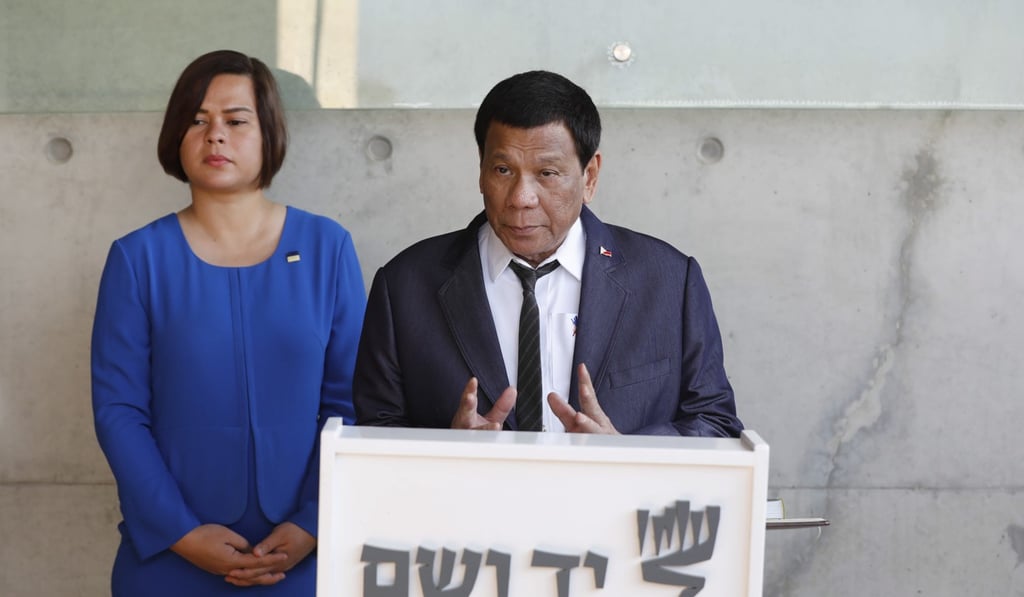 Duterte and his daughter Sarah at the museum, where he lamented the Nazi genocide. Photo: EPA-EFE