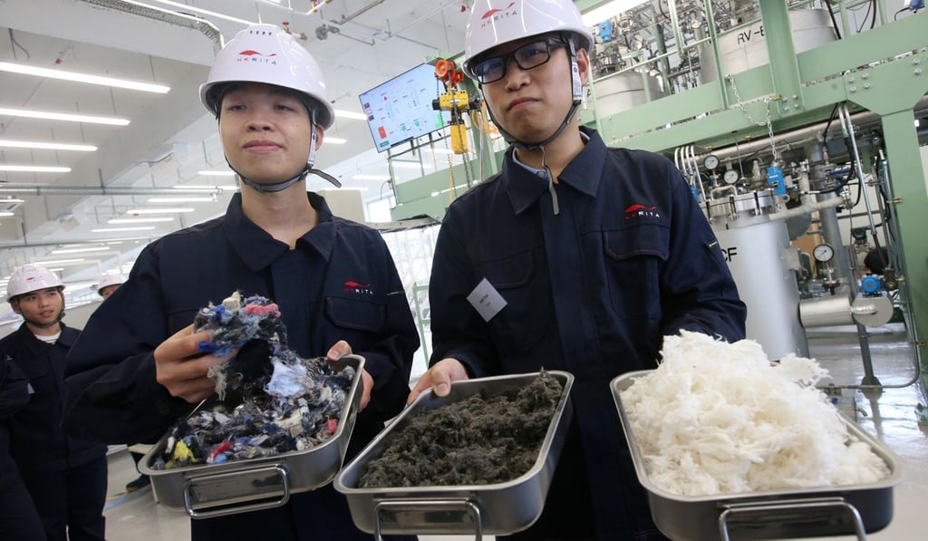 Workers display recycled materials. Photo: David Wong