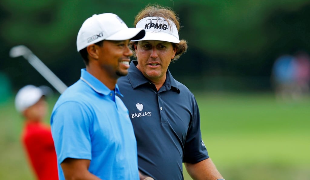 Tiger Woods (L) and Phil Mickelson on the fairway during the first round of the Deutsche Bank Championship. Photo: Reuters