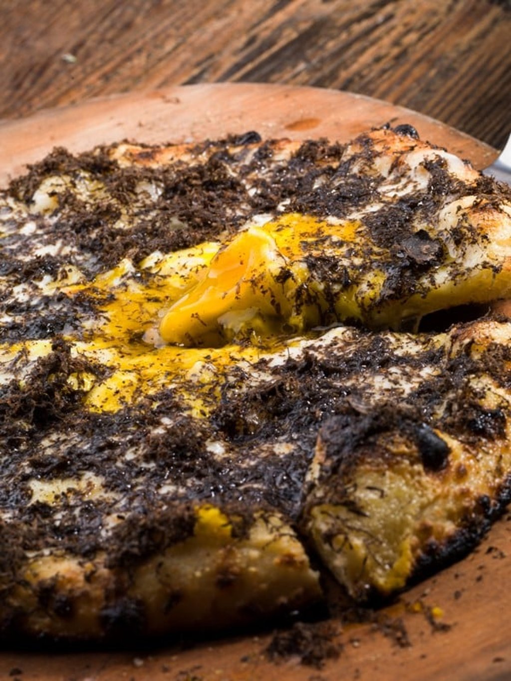 The black truffle, three cheeses and farm egg pizza at Mercato by Jean-Georges in Hong Kong.