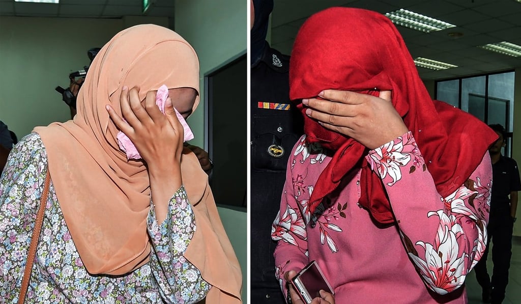 The two women who were caned for attempting lesbian sex. Photo: EPA