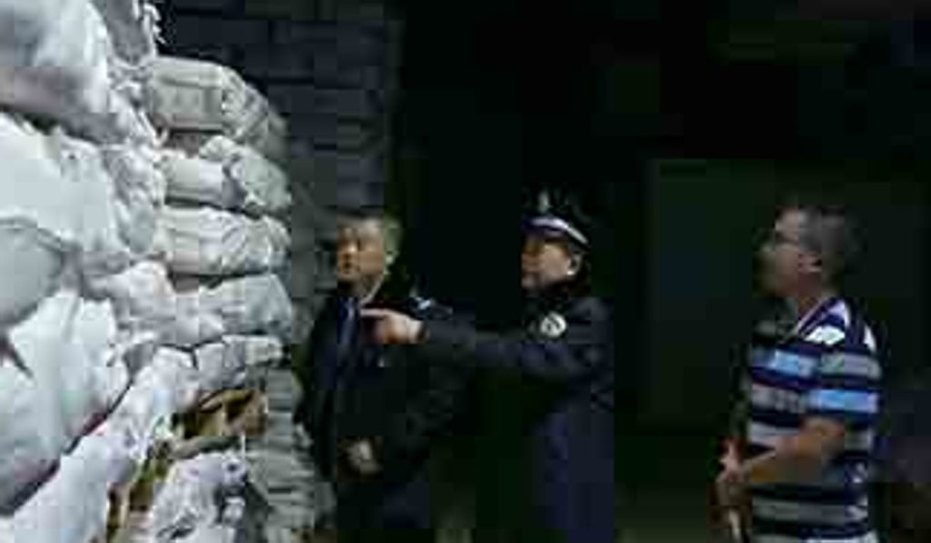 Authorities inspect the goods at one of storage facilities they visited in Chongqing. Photo: Weibo