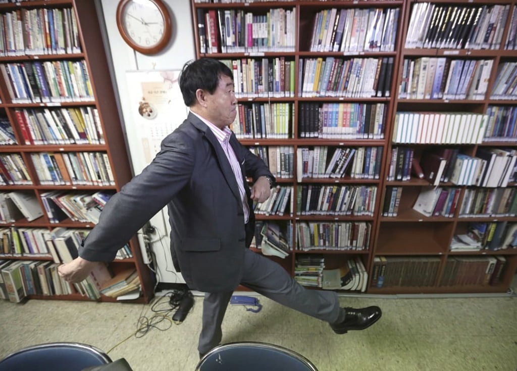 Sim Ju-il goose-steps during an interview in Seoul. Photo: AP