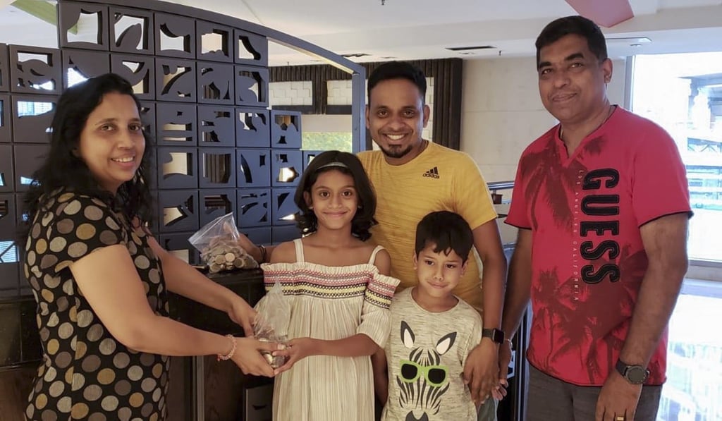Dia (front left) and Sid Rahul (front right) donated their savings to the relief effort.