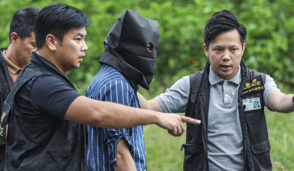 Police officers and the suspect at the reconstruction. Photo: Roy Issa