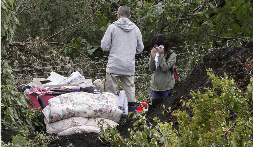 People gather their belongings after a large landslide site in the Yoshino district of Atsuma in Hokkaido, Japan on September 8, 2018. Photo: EPA
