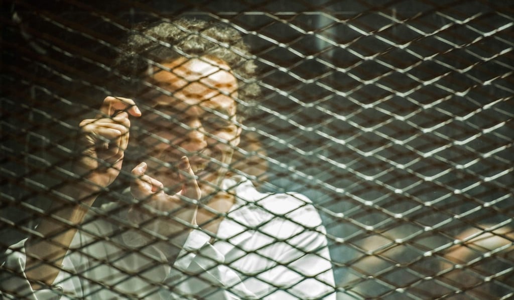 Egyptian photojournalist Mahmoud Abu Zeid, known as Shawkan, inside a soundproof glass dock during his trial in Cairo on September 8, 2018. Photo: AFP Egyptian photojournalist Mahmoud Abu Zeid, known as Shawkan, inside a soundproof glass dock during his trial in Cairo on September 8, 2018. Photo: AFP