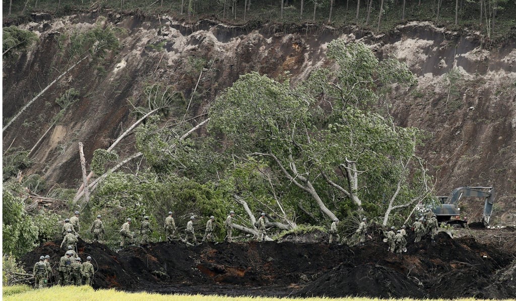 Japan’s Ground Self-Defence personnel join rescue teams at a large landslide site in Atsuma. Photo: EPA Japan’s Ground Self-Defence personnel join rescue teams at a large landslide site in Atsuma. Photo: EPA