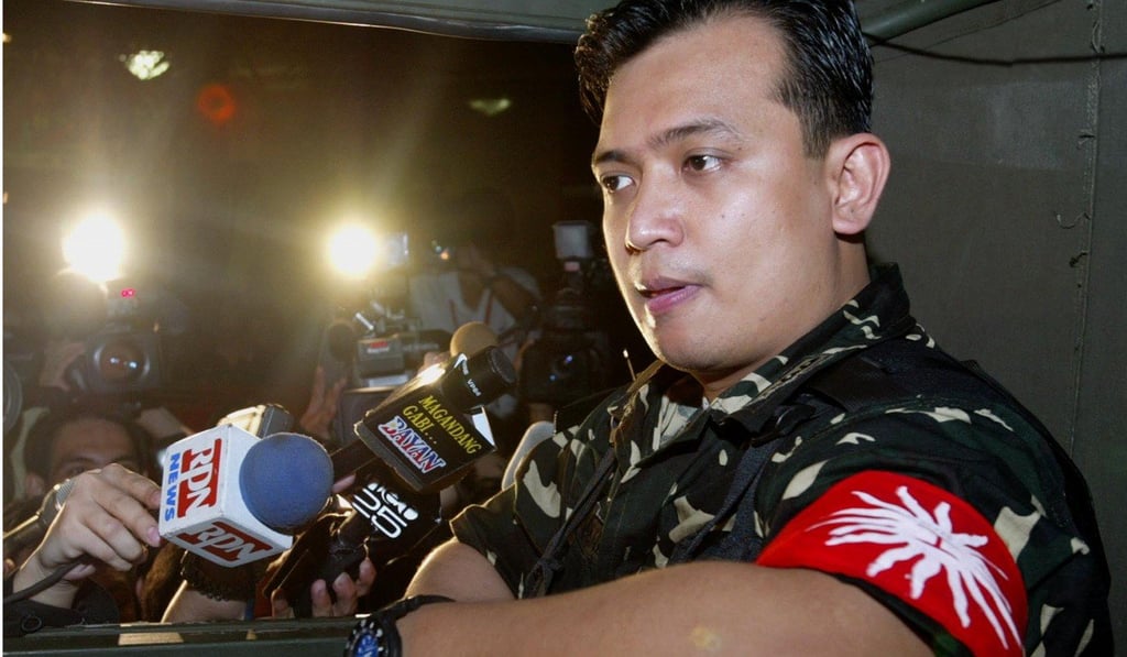 Trillanes sitting in a military truck after leaving the Oakwood hotel in Makati on July 27, 2003. Photo: AP