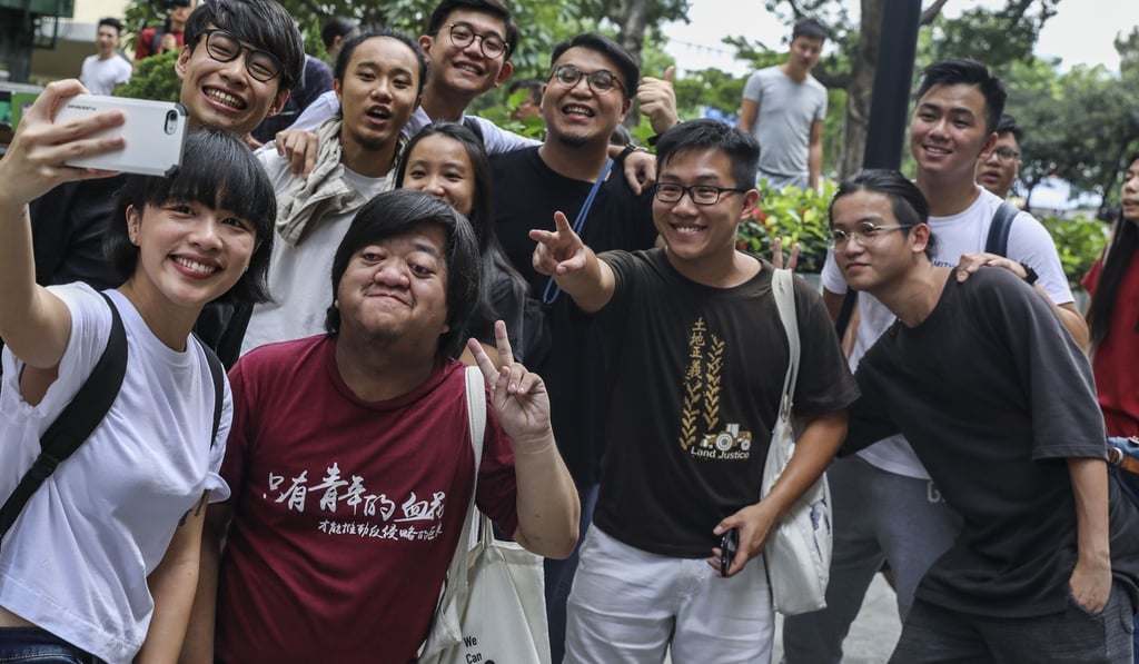 Raphael Wong Ho-ming (second from front right) celebrates with others outside the Court of Final Appeal after being granted their freedom. Photo: Sam Tsang
