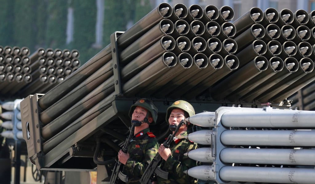 Soldiers ride a multiple rocket launcher. Photo: Reuters