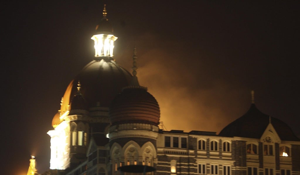 Smoke emerges from behind a dome on the Taj Hotel in Mumbai during the attack. Photo: AP