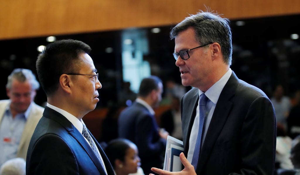 Chinese Ambassador to the WTO Zhang Xiangchen (left) talks to his US counterpart Dennis Shea, before the WTO general council meeting in Geneva, Switzerland, on July 26. Photo: Reuters