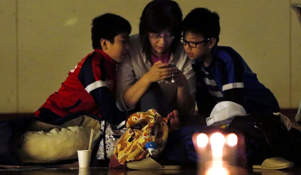 A family at an evacuation shelter in Sapporo. Photo: Reuters