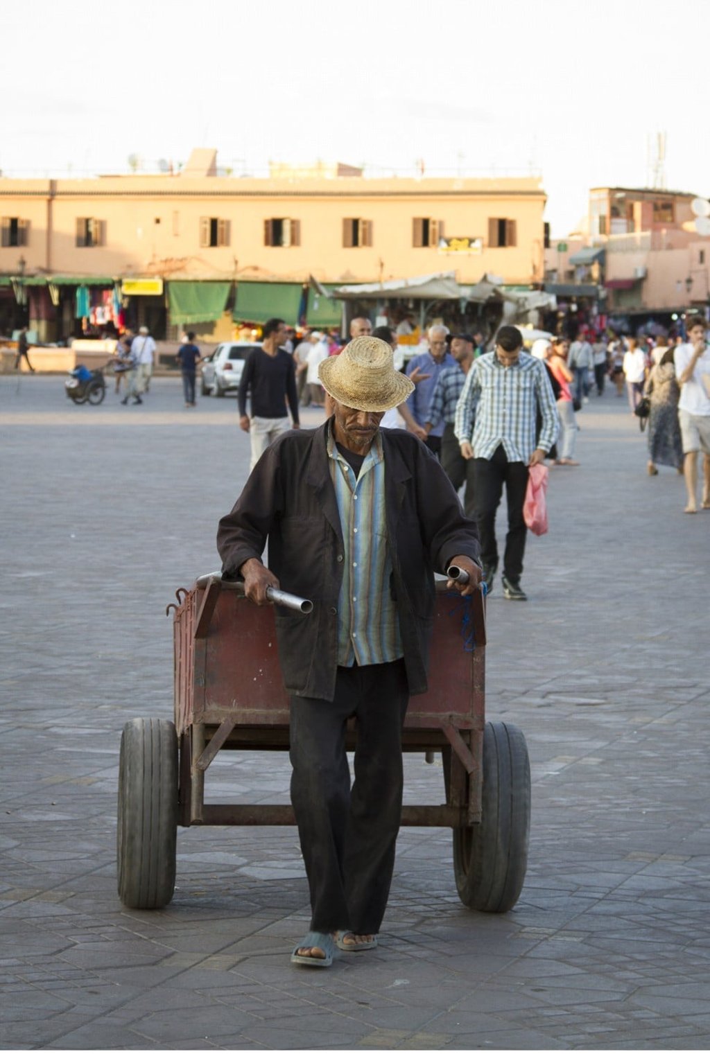 A stallholder walks through Jemaa el-Fnaa in Marrakesh. Photo: James Wendlinger