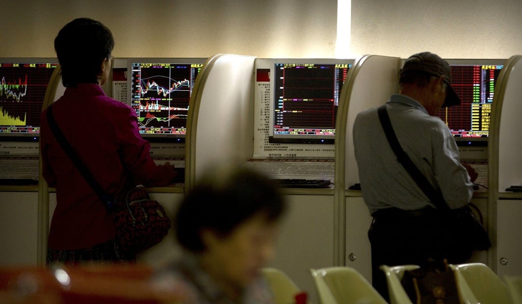Mainland China investors use computer terminals as they monitor stock prices at a brokerage house in Beijing. Photo: AP