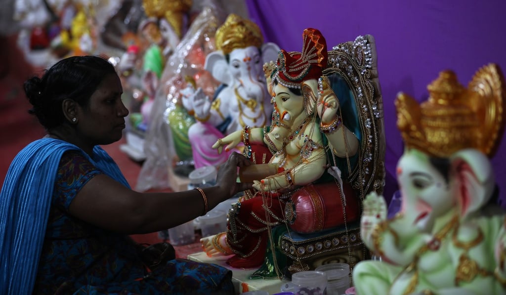 An artist works on an idol of the elephant-headed Hindu God Ganesh at a workshop in Mumbai on September 5, in time for the Ganesh Chaturti festival. The rupee fell to an all-time low last week. Photo: EPA-EFE