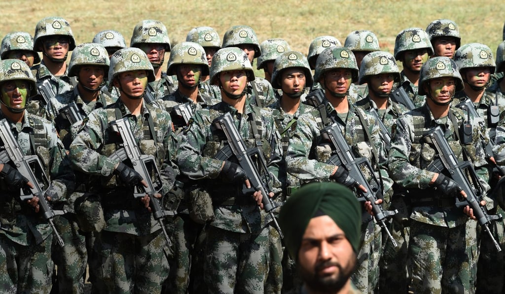 An Indian Army soldier in front of a group of People's Liberation Army soldiers in a 2016 anti-terror drill. Nepal has pulled out of a military exercise with India, but plans to conduct one with China. Photo: AFP