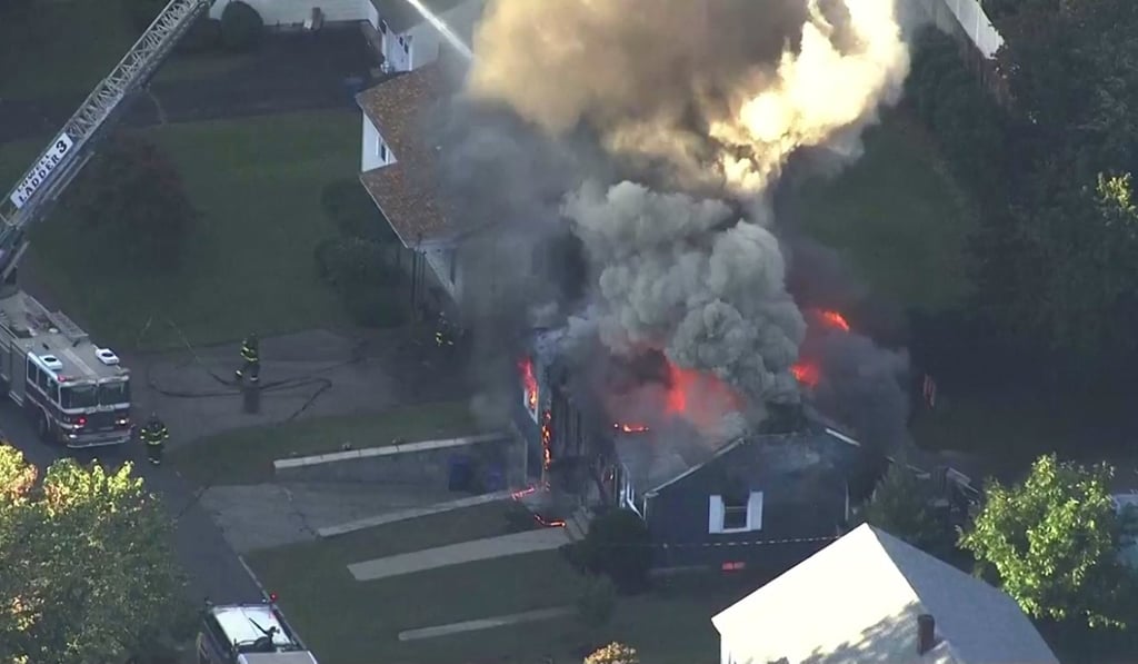 In this image take from video provided by WCVB in Boston, firefighters battle a raging house fire in Lawrence, a suburb of Boston, on Thursday. Photo: WCVB via AP In this image take from video provided by WCVB in Boston, firefighters battle a raging house fire in Lawrence, a suburb of Boston, on Thursday. Photo: WCVB via AP
