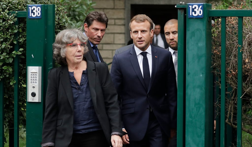 French President Emmanuel Macron walks next to Michele Audin, daughter of the late Maurice Audin, as he leaves the home of Josette Audin, widow of Audin, on Thursday in Bagnolet. Photo: Agence France-Presse French President Emmanuel Macron walks next to Michele Audin, daughter of the late Maurice Audin, as he leaves the home of Josette Audin, widow of Audin, on Thursday in Bagnolet. Photo: Agence France-Presse