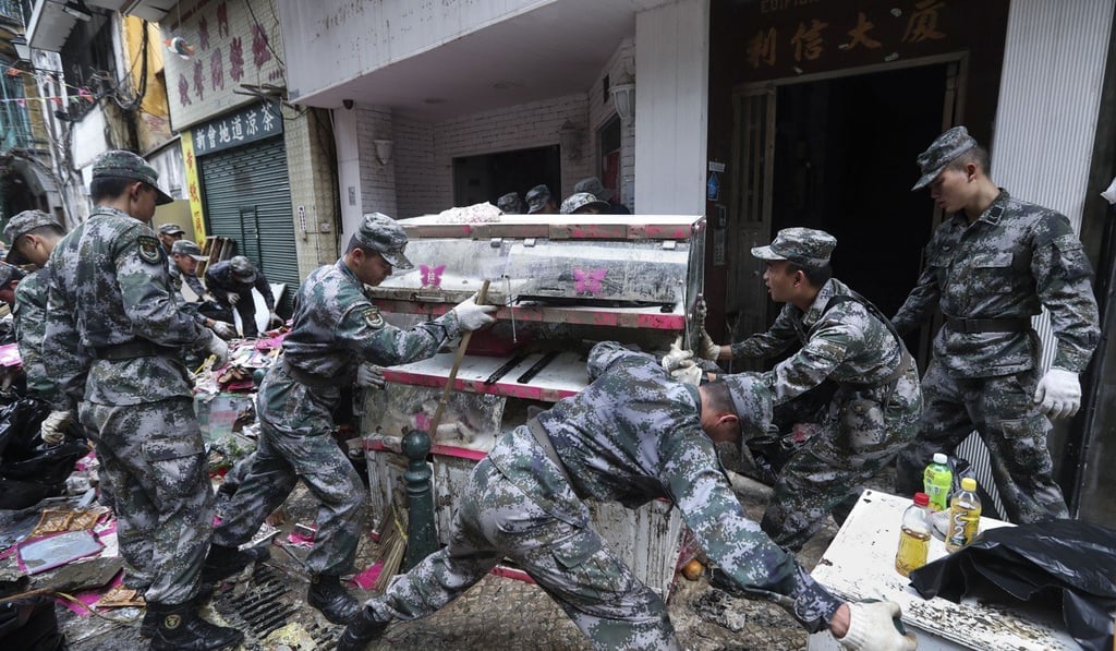 Troops from the People’s Liberation Army help Macau residents get the city back to normal after Hato. Photo: Edward Wong
