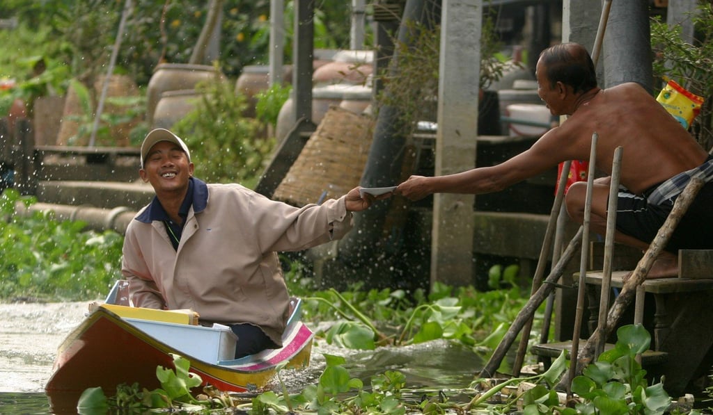 A postman delivers a letter along one of Bangkok’s canals in 2004. Photo: Sasa Kralj