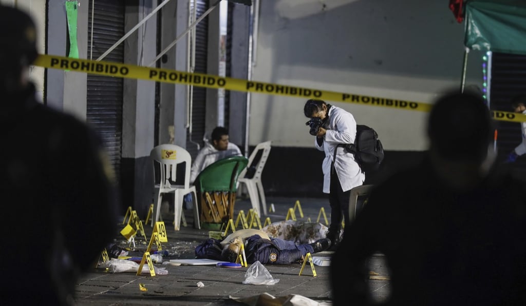 Forensic investigators at Garibaldi Plaza after the shooting. Photo: AP
