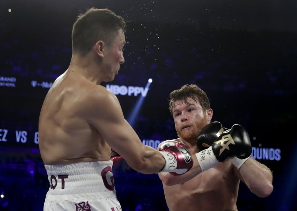 Gennady Golovkin and Canelo Alvarez trade punches in the second. Photo: AP
