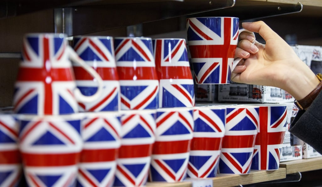 A woman looks at merchandise for sale in a souvenir shop on Whitehall in London. Photo: Agence Freance-Presse