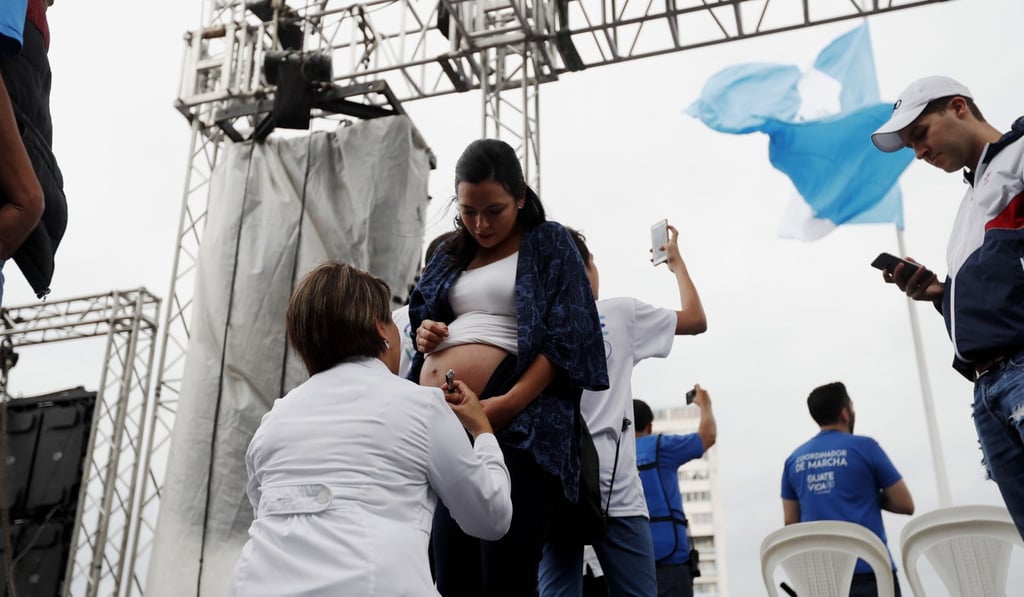 A doctor checking a pregnant woman during an anti-abortion march, in Guatemala City, Guatemala, this month. Air pollution significantly increases the risk of premature birth and of low birthweight. Photo: EPA-EFE