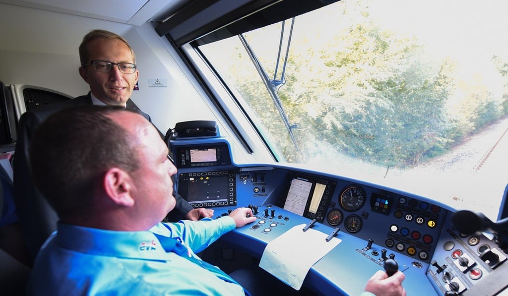 Henri Poupart-Lafarge (L), Chairman and CEO of Alstom talks to the driver of the world's first hydrogen fuel cell train. Photo: EPA