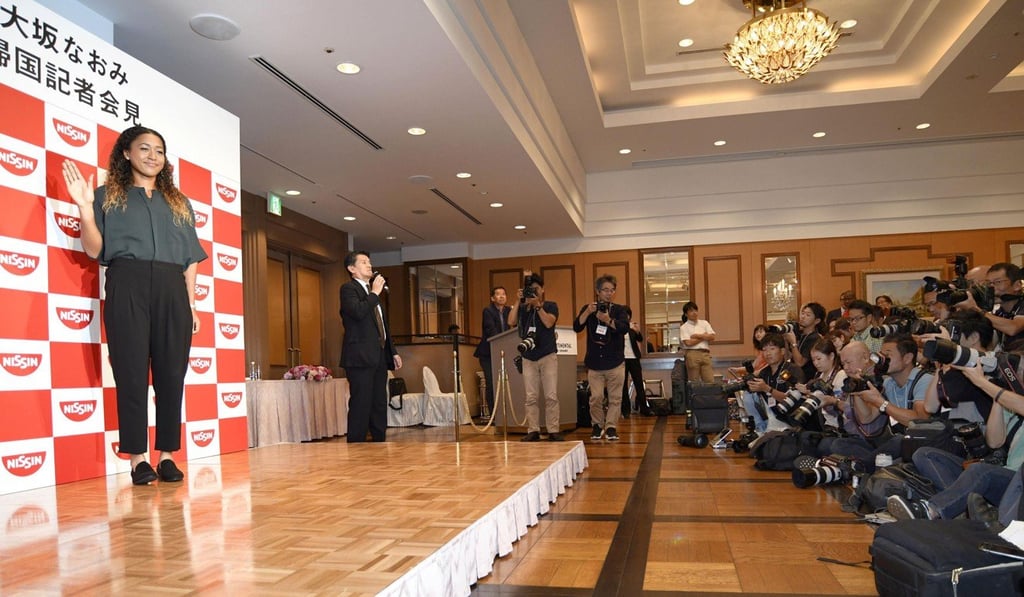 Osaka poses at a press conference in Yokohama after her arrival back in Japan. Photo: Kyodo