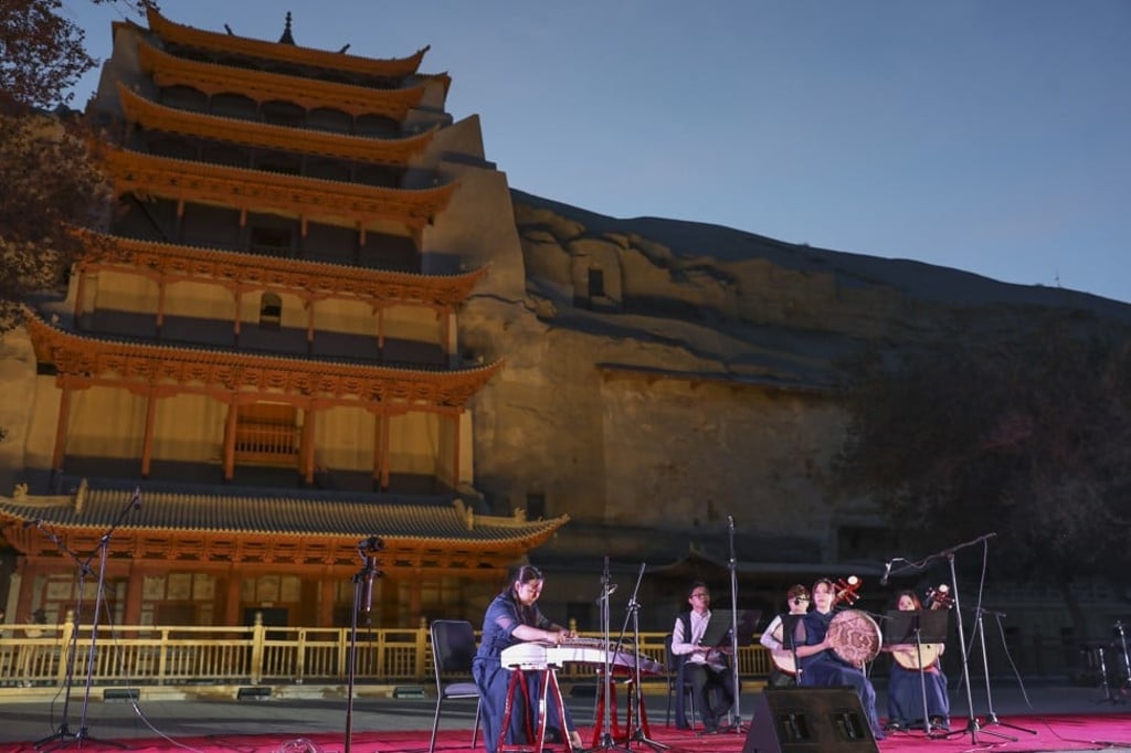 Musicians of Gaudeamus Dunhuang Ensemble from Hong Kong perform in front of the Nine-Storey Pagoda at the Mogao Caves. Photo: Simon Song