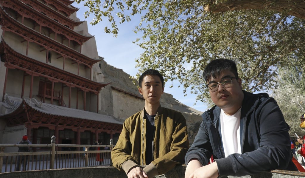 Composers Kahlen Kam (left) and Chu Kai-yeung in front of the Nine-Storey Pagoda at the Mogao Caves in Dunhuang ahead of a performance of their music inspired by the ancient grottoes. Photo: Simon Song