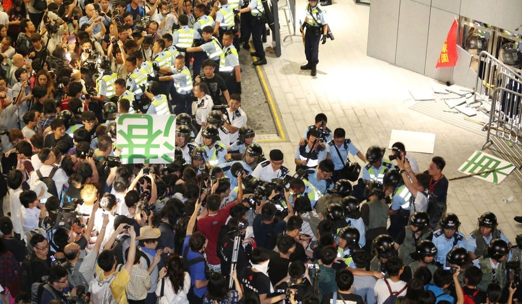 Activists clash with police during a protest against a Northeast New Territories development plan, outside the Legislative Council in 2004. Photo: Felix Wong