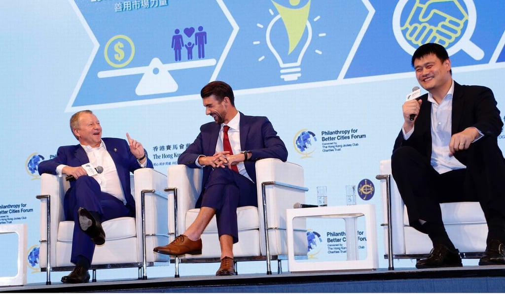 Michael Phelps (centre) shares a joke with Jockey Club chief executive Winfried Engelbrecht-Bresges (left) and retired NBA star Yao Ming at the Philanthropy for Better Cities Forum at Convention Centre. Photo: Hong Kong Jockey Club Michael Phelps (centre) shares a joke with Jockey Club chief executive Winfried Engelbrecht-Bresges (left) and retired NBA star Yao Ming at the Philanthropy for Better Cities Forum at Convention Centre. Photo: Hong Kong Jockey Club