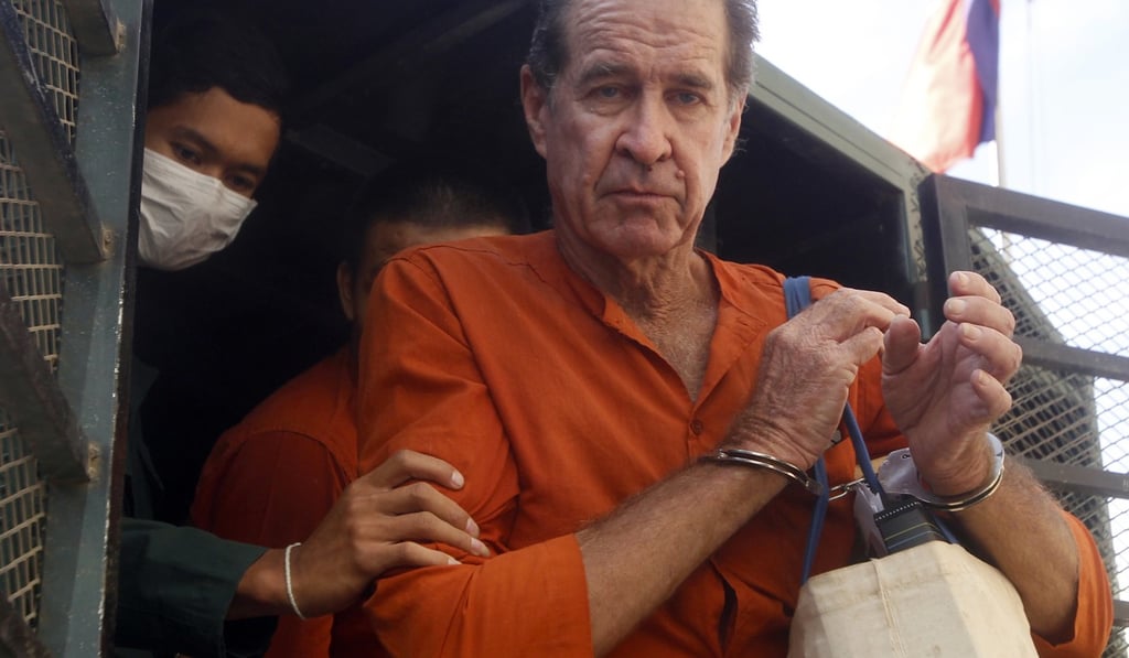 Ricketson being helped off a prisoner truck upon his arrival at Phnom Penh Municipal Court. Photo: AP