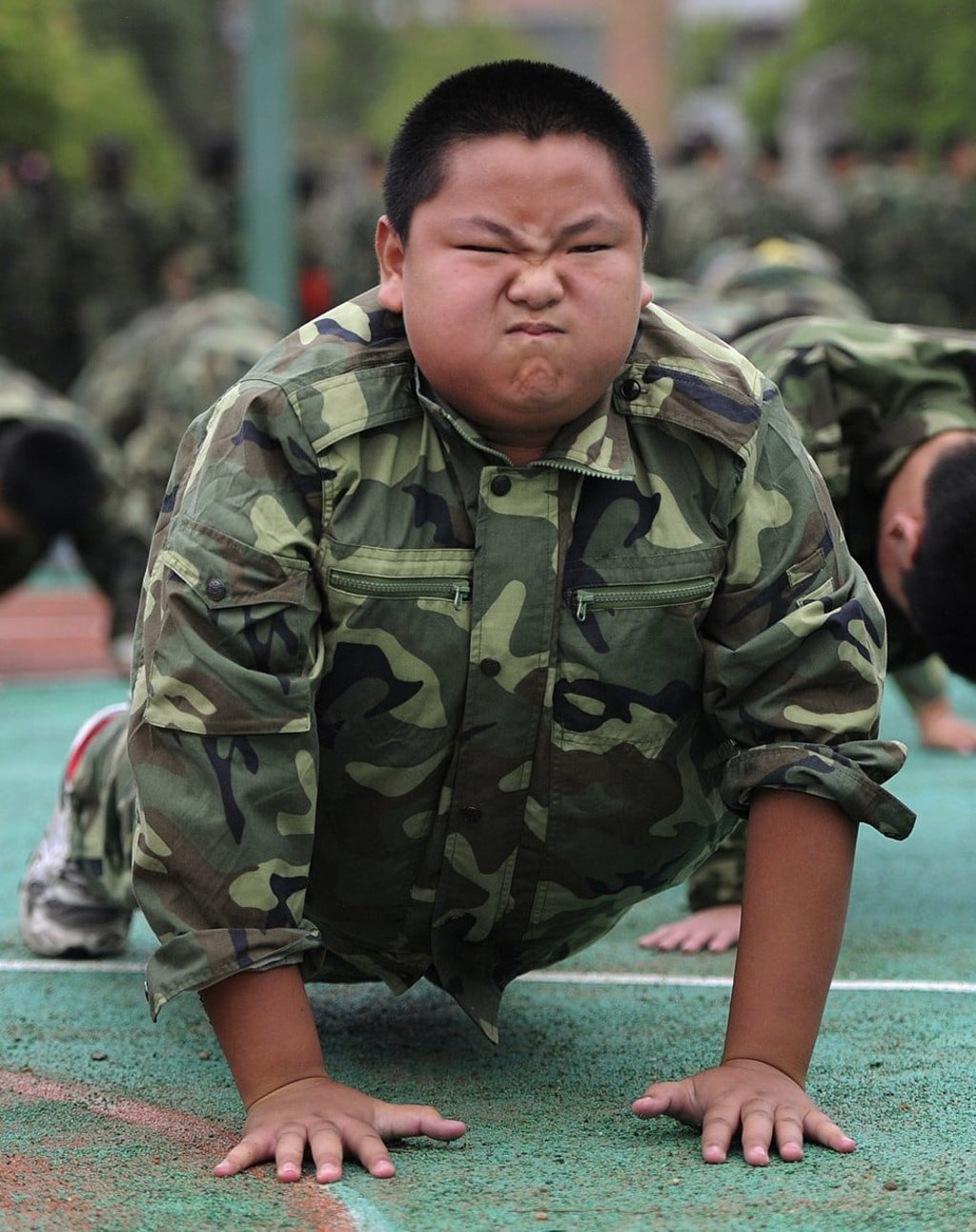 A primary school pupil takes part in a military school strength building session in Hefei, Anhui. Photo: Reuters
