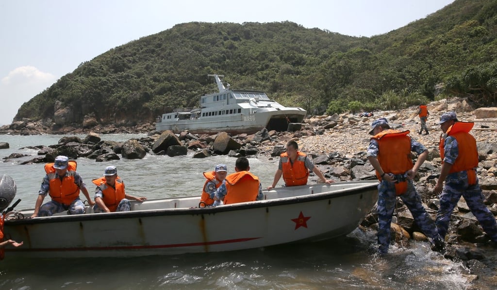 Personnel had been guarding the boat since it ran aground. Photo: Sam Tsang