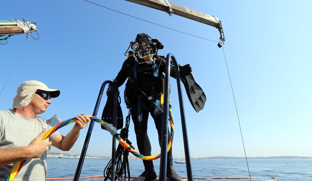 A diver and crew member of the Ocea vessel takes part in an operation to remove tyres from the Mediterranean Sea. Photo: AFP A diver and crew member of the Ocea vessel takes part in an operation to remove tyres from the Mediterranean Sea. Photo: AFP