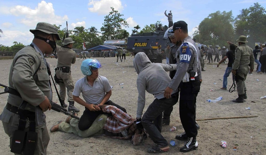 Police arrest a man at a ceremony to commemorate the 50th anniversary of West Papua's independence from Dutch rule in 2011. Photo: Reuters