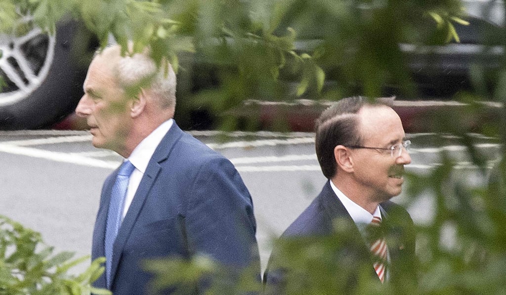 White House Chief of Staff John Kelly and Rod Rosenstein step away following a meeting at the White House in Washington on Monday. Photo: AFP