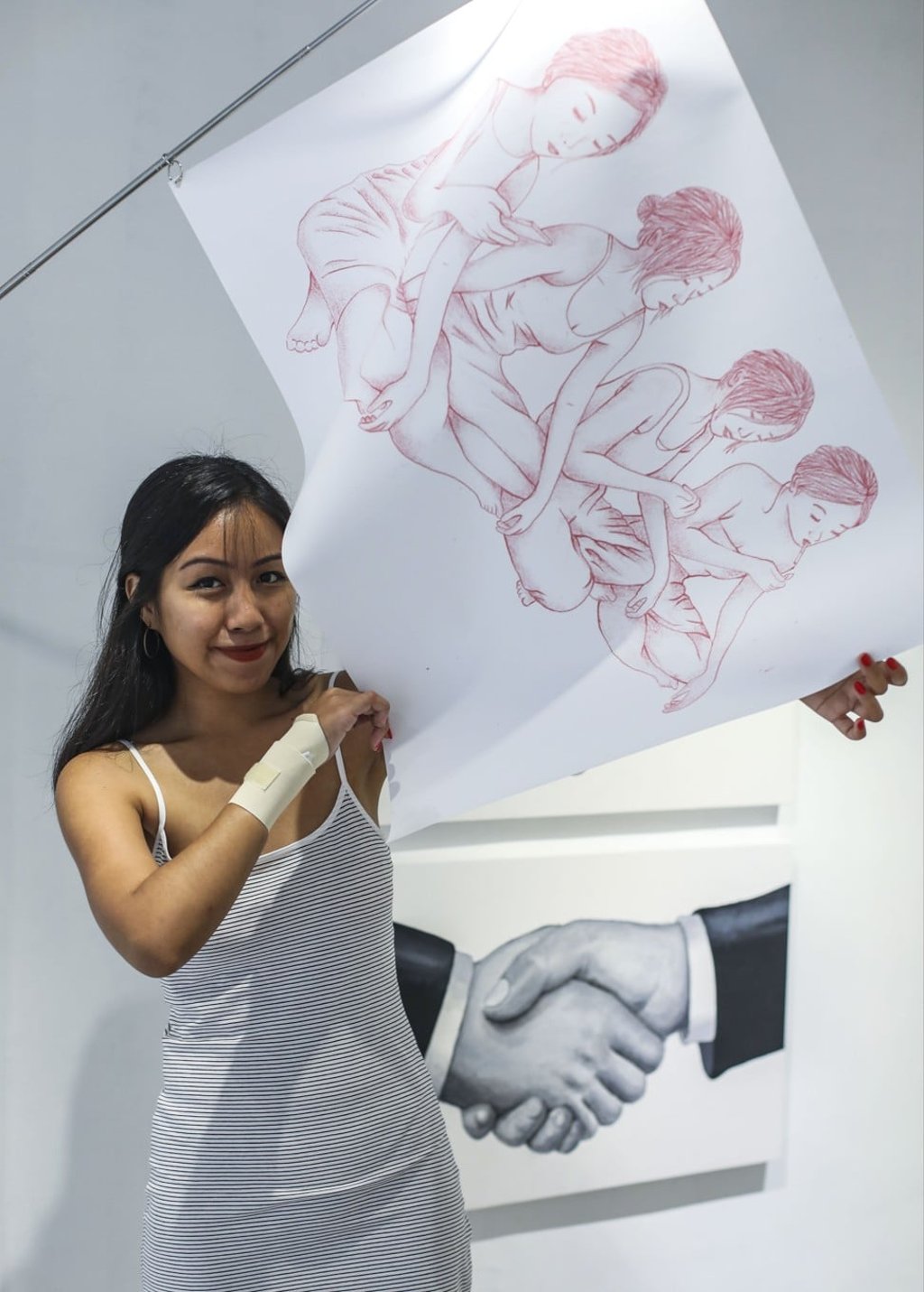 Malaysian artist Engku Iman holds one of her illustrated flags, the fruit of a recent residency in Japan. Photo: Xiaomei Chen