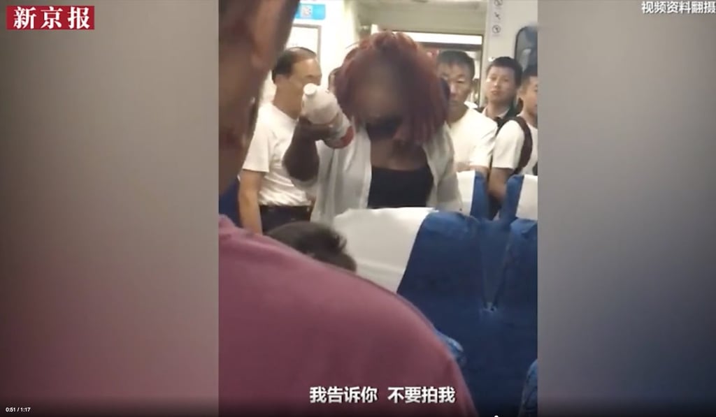 The woman threw water at her fellow passengers when they filmed her altercation after she was accused of taking someone else's seat. Photo: the paper The woman threw water at her fellow passengers when they filmed her altercation after she was accused of taking someone else's seat. Photo: the paper